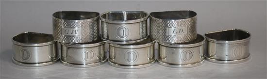 A set of six 1940s silver napkin rings and a pair of engine turned napkin rings.